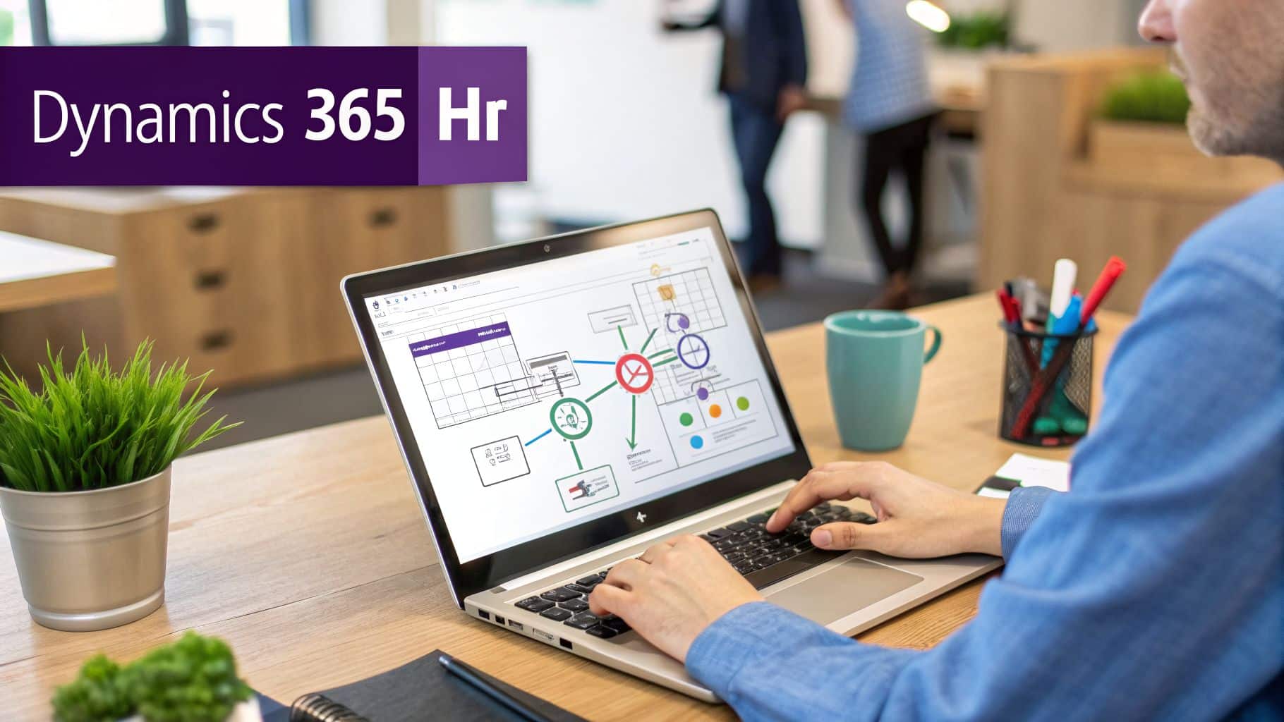Person typing on a laptop displaying a Dynamics 365 Hr diagram in an office setting.