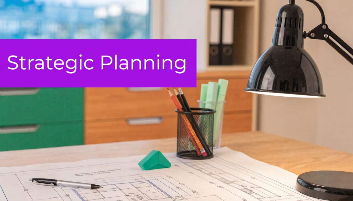 A professional desk featuring blueprints, pens, a green eraser, and a lamp with a strategic planning title.