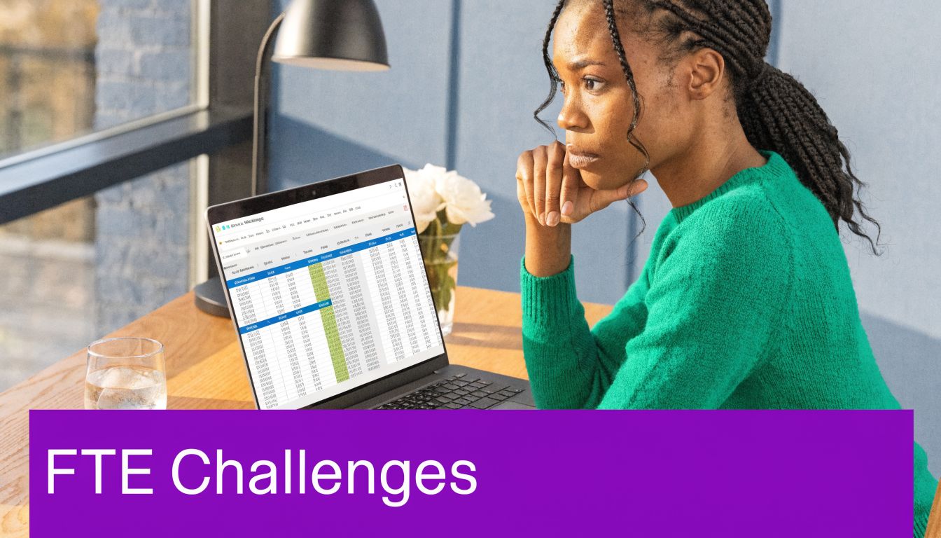 A focused young woman in a green sweater works on a laptop displaying financial data spreadsheets.