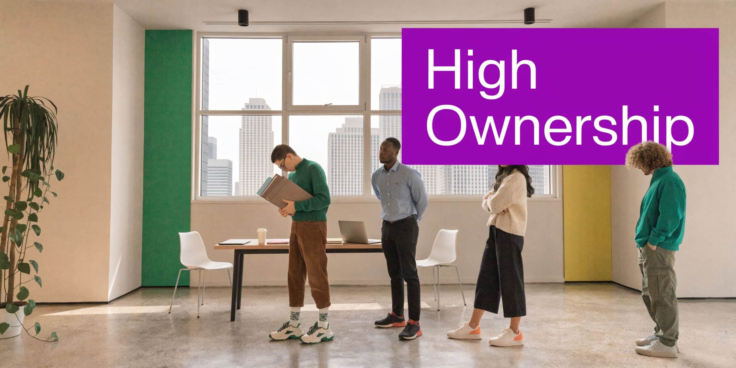 A diverse group of professional colleagues standing in a brightly lit modern office space with large windows.